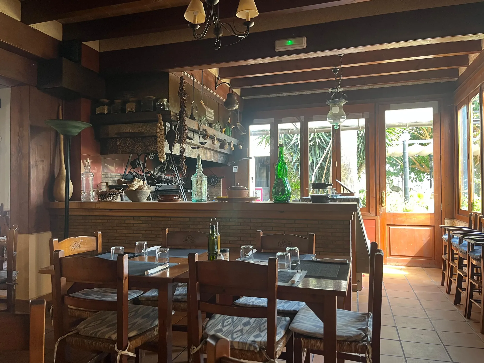 Indoor dining room with a wooden bar and laid tables